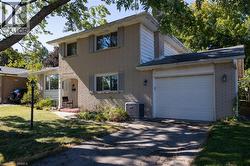 Brick exterior with white siding accents and a single-car garage - 