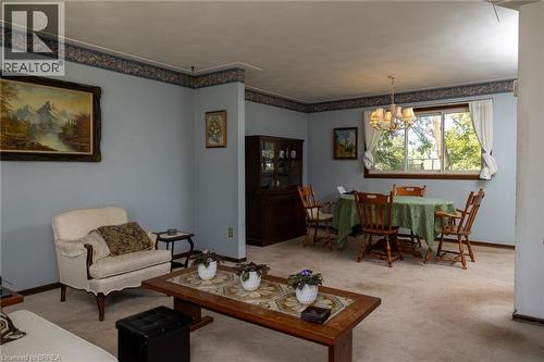 Expansive living space with light blue walls and decorative wallpaper border - 52 Brier Park Road, Brantford, ON 