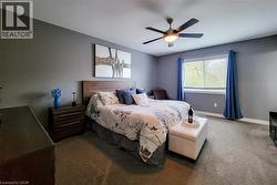 Wall-to-wall carpeting, window with blinds, and a built-in ceiling fan with light - 
