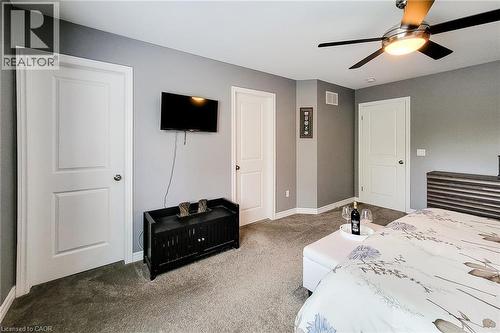 Recessed lighting, ceiling fan with integrated lighting, wall-mounted television, and carpeted flooring - 4274 Sixth Avenue, Niagara Falls, ON 