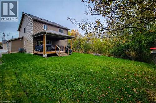 Expansive rear lawn with mature trees, covered deck, and exterior siding - 4274 Sixth Avenue, Niagara Falls, ON 