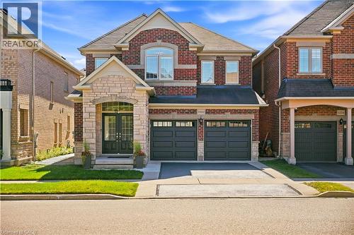 Brick and stone facade with arched entry and double front doors - 3352 Hiscott Avenue, Burlington, ON 