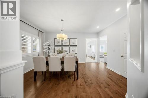 Hardwood flooring, recessed lighting, white interior doors, plantation shutters, and a drum pendant light fixture - 3352 Hiscott Avenue, Burlington, ON 