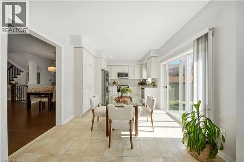 Gourmet kitchen with white cabinetry and stainless steel appliances - 3352 Hiscott Avenue, Burlington, ON 