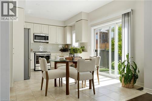 Kitchen with light-toned cabinetry, stainless steel appliances, and a tile backsplash - 3352 Hiscott Avenue, Burlington, ON 