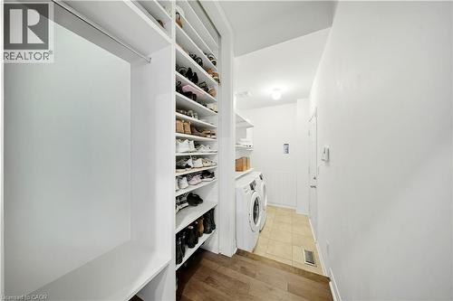 Built-in shelving and hanging rod with wood-finish flooring - 3352 Hiscott Avenue, Burlington, ON 
