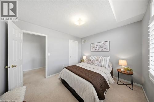 Soft gray wall paint with white trim, plush carpet flooring, recessed ceiling feature, and white interior doors - 3352 Hiscott Avenue, Burlington, ON 