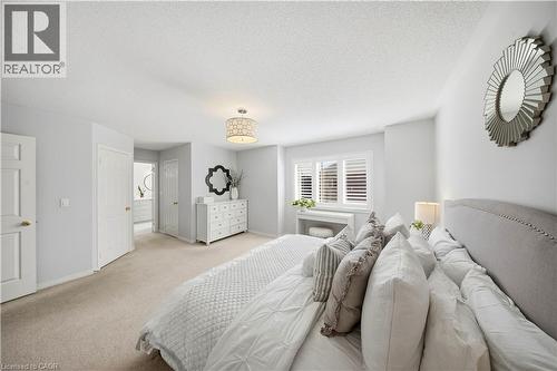Neutral-toned carpeting, window shutters, and an upholstered headboard - 3352 Hiscott Avenue, Burlington, ON 