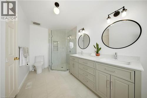 Dual vanity with quartz countertops, undermount sinks, and contemporary matte black-framed mirrors - 3352 Hiscott Avenue, Burlington, ON 