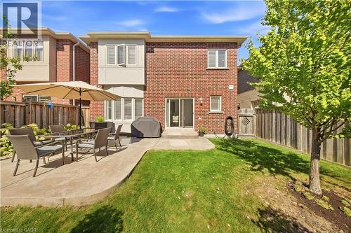 Brick exterior with two stories, a ground-level patio, and a grassy yard - 3352 Hiscott Avenue, Burlington, ON 