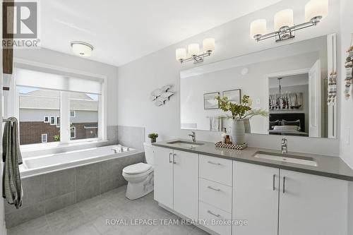 5pc ensuite: 2 sinks, stone counters, tub & shower - 715 Maverick Crescent, Ottawa, ON 