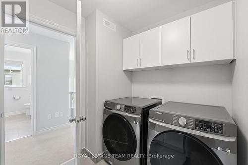 Upper floor laundry room w/ upper cabinets - 715 Maverick Crescent, Ottawa, ON 