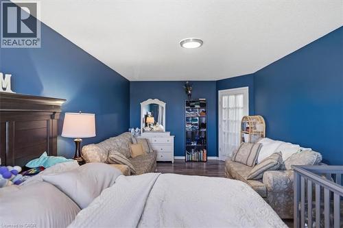 Wood-finish flooring with vibrant wall color and white trim - 4804 John Street, Beamsville, ON 