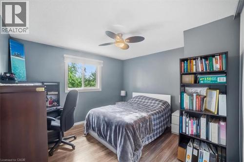 Wood-finish flooring, ceiling fan, built-in shelving, and a window with natural light - 4804 John Street, Beamsville, ON 