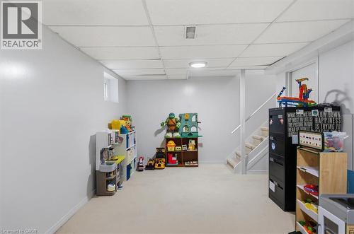 Recessed window, drop ceiling, wall-to-wall carpeting, painted walls, and staircase with handrail - 4804 John Street, Beamsville, ON 