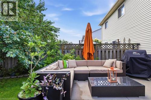 Patio area with concrete pavers, perimeter fencing, and mature trees - 4804 John Street, Beamsville, ON 