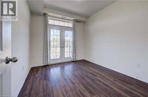 French doors with louvered blinds open to a balcony - 403 Westwood Drive Unit# 59, Kitchener, ON 