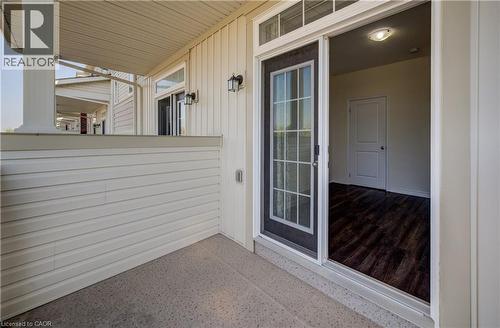 Covered outdoor patio with a concrete surface and cream-colored siding - 403 Westwood Drive Unit# 59, Kitchener, ON 