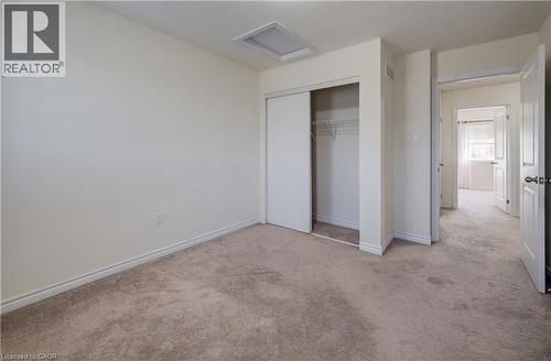 Neutral-toned wall-to-wall carpeting and off-white walls - 403 Westwood Drive Unit# 59, Kitchener, ON 