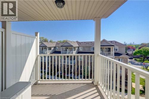 Private balcony featuring a concrete floor, white spindle railing, and a vinyl privacy wall - 403 Westwood Drive Unit# 59, Kitchener, ON 