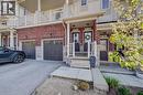 Multi-level townhouse exterior featuring red brick and light-toned siding - 403 Westwood Drive Unit# 59, Kitchener, ON 