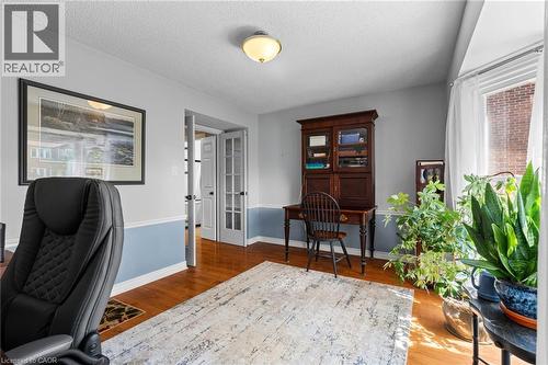 Hardwood flooring, painted walls with a chair rail, bright window with drapes, and a ceiling-mounted light fixture - 1610 Heathside Crescent, Pickering, ON 