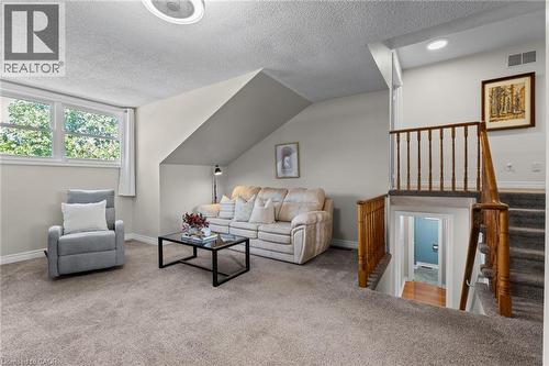 Carpeted flooring, white trim, wood railings, and a window with exterior foliage - 1610 Heathside Crescent, Pickering, ON 