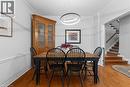 Hardwood flooring, crown molding, chair rail molding, modern linear pendant light fixture, and staircase with carpeted treads - 1610 Heathside Crescent, Pickering, ON 