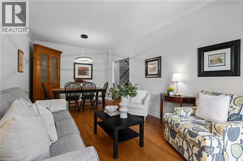 Hardwood flooring throughout, crown molding, recessed lighting, and a modern circular pendant light fixture - 1610 Heathside Crescent, Pickering, ON 
