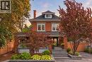 Red brick exterior with a dark shingle roof and white trim - 283 Plains Road W, Burlington, ON 