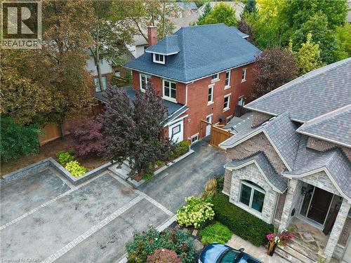 Brick and stone exterior with a multi-gabled roofline - 283 Plains Road W, Burlington, ON 