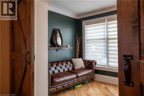Wood-finish flooring with a barn door entry - 283 Plains Road W, Burlington, ON 