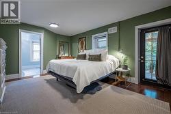Hardwood flooring, wall-mounted sconce, and French door - 