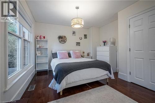 Hardwood-finish flooring, white trim, and a paneled door - 283 Plains Road W, Burlington, ON 