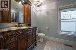 Ornate wood vanity with a stone countertop and integrated sink - 