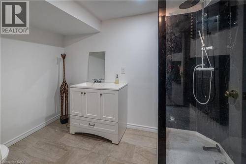 White vanity with integrated sink, chrome faucet, and mirrored cabinet - 283 Plains Road W, Burlington, ON 