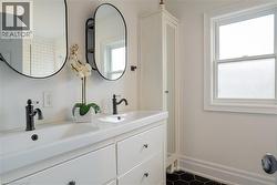 Dual vanity with integrated sinks and matte black fixtures - 