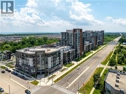 Modern mid-rise building with a mixed-material facade and multiple balconies - 10 Mallard Trail Unit# 237, Waterdown, ON 