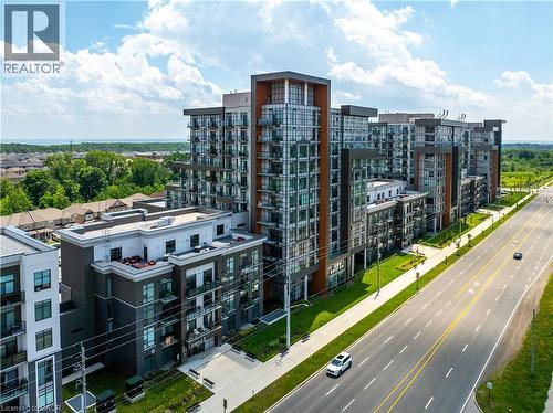 Modern multi-story building featuring extensive glazing, private balconies, and contemporary facade elements - 10 Mallard Trail Unit# 237, Waterdown, ON 