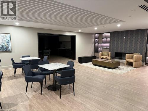 Spacious common area featuring wood-finish flooring, recessed lighting, and a decorative slatted ceiling - 10 Mallard Trail Unit# 237, Waterdown, ON 