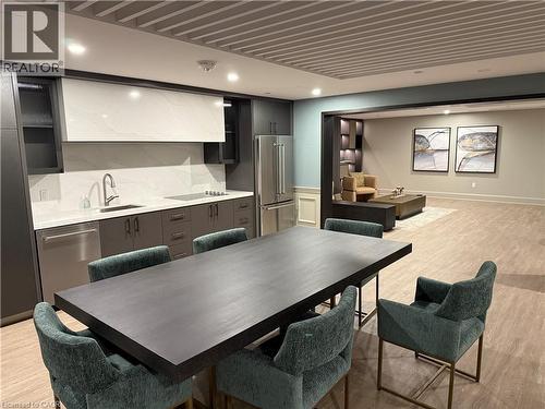 Recessed lighting and a slatted ceiling treatment complement the light wood-finish flooring - 10 Mallard Trail Unit# 237, Waterdown, ON 
