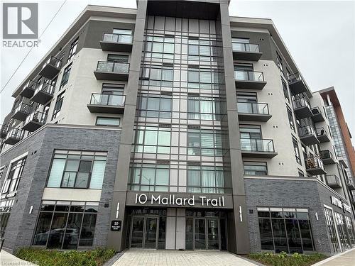 Contemporary building facade featuring grey brick, stucco, and extensive glazing - 10 Mallard Trail Unit# 237, Waterdown, ON 