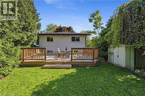 Expansive green lawn with newer, full sized wood deck, surrounded by mature trees and natural landscaping. Original shed. - 450 Brigadoon Drive, Hamilton, ON 
