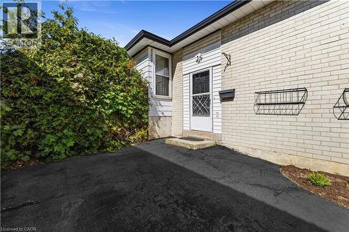 Main entry to the home, second entry on opposite side of the home.  Paved driveway easily fits 2 cars. - 450 Brigadoon Drive, Hamilton, ON 