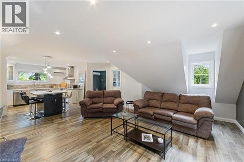 Guest house living area with ample windows, recessed lighting and open concept, sofa set show in photos is included - 515 Hamilton Drive, Ancaster, ON 