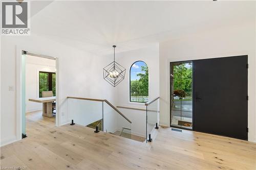 Luxury flooring throughout main level, glass rail with oak open riser staircase, large windows for lots of natural light - 515 Hamilton Drive, Ancaster, ON 