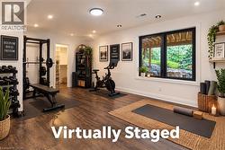 Virtually staged photo - reconfigure basement bedroom to work out area - 