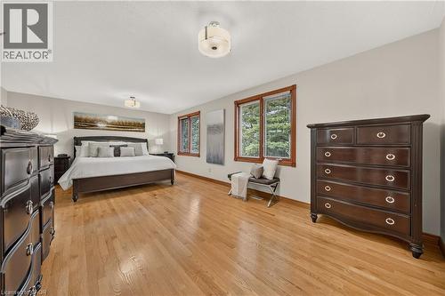 Hardwood flooring throughout, multiple large windows with wood-finish trim, and recessed lighting - 52 Archwood Crescent, Cambridge, ON 