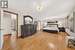 Hardwood flooring, painted walls, ceiling-mounted light fixtures, and wood-trimmed window - 