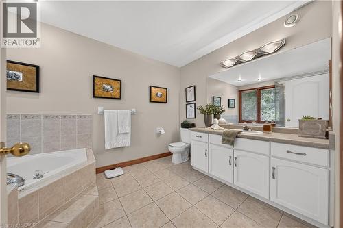 Expansive vanity with double sinks, white cabinetry, and a large mirror - 52 Archwood Crescent, Cambridge, ON 